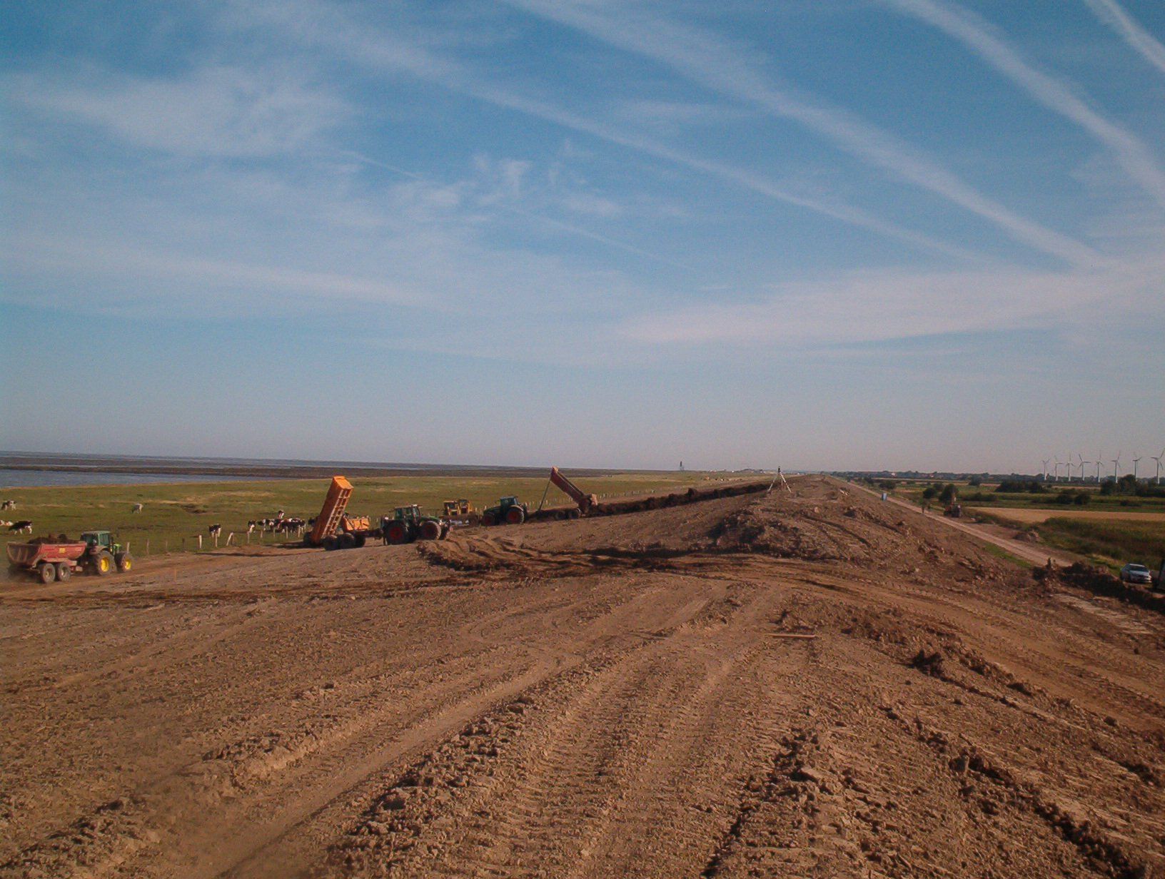 Baustelle mit schwerem Gerät, Rodungsarbeiten unter blauem Himmel.