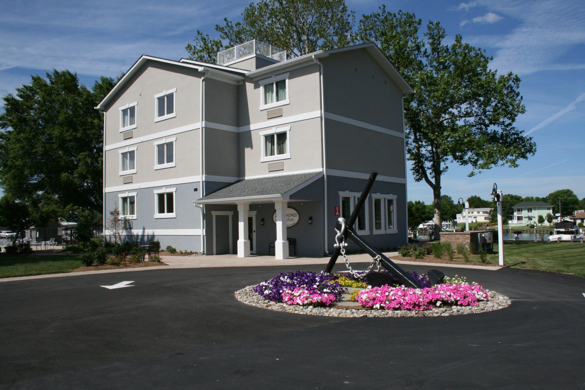 front of Anhored Inn with anchor in bed of flowers