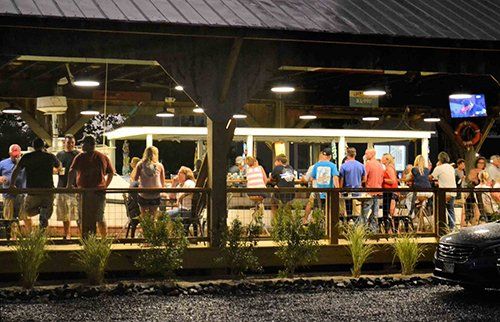 Night view of customers at Boat House at Hidden Harbour