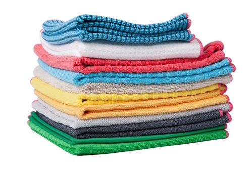 A pile of towels of different colors are stacked on top of each other.