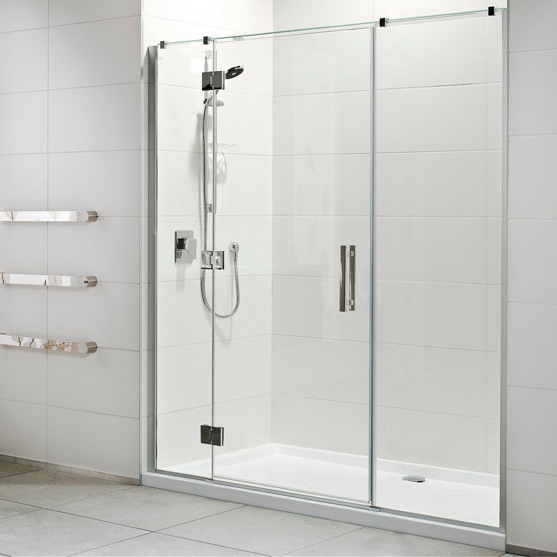 A bathroom with a sliding glass shower door and a shower head.