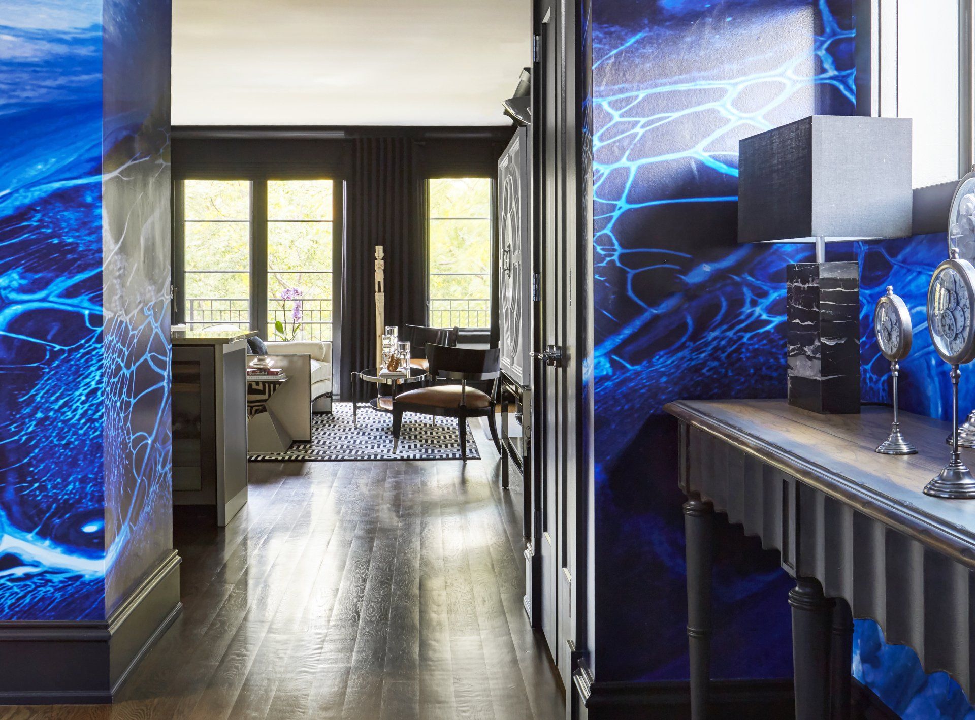 A hallway in a house with blue walls and a table.