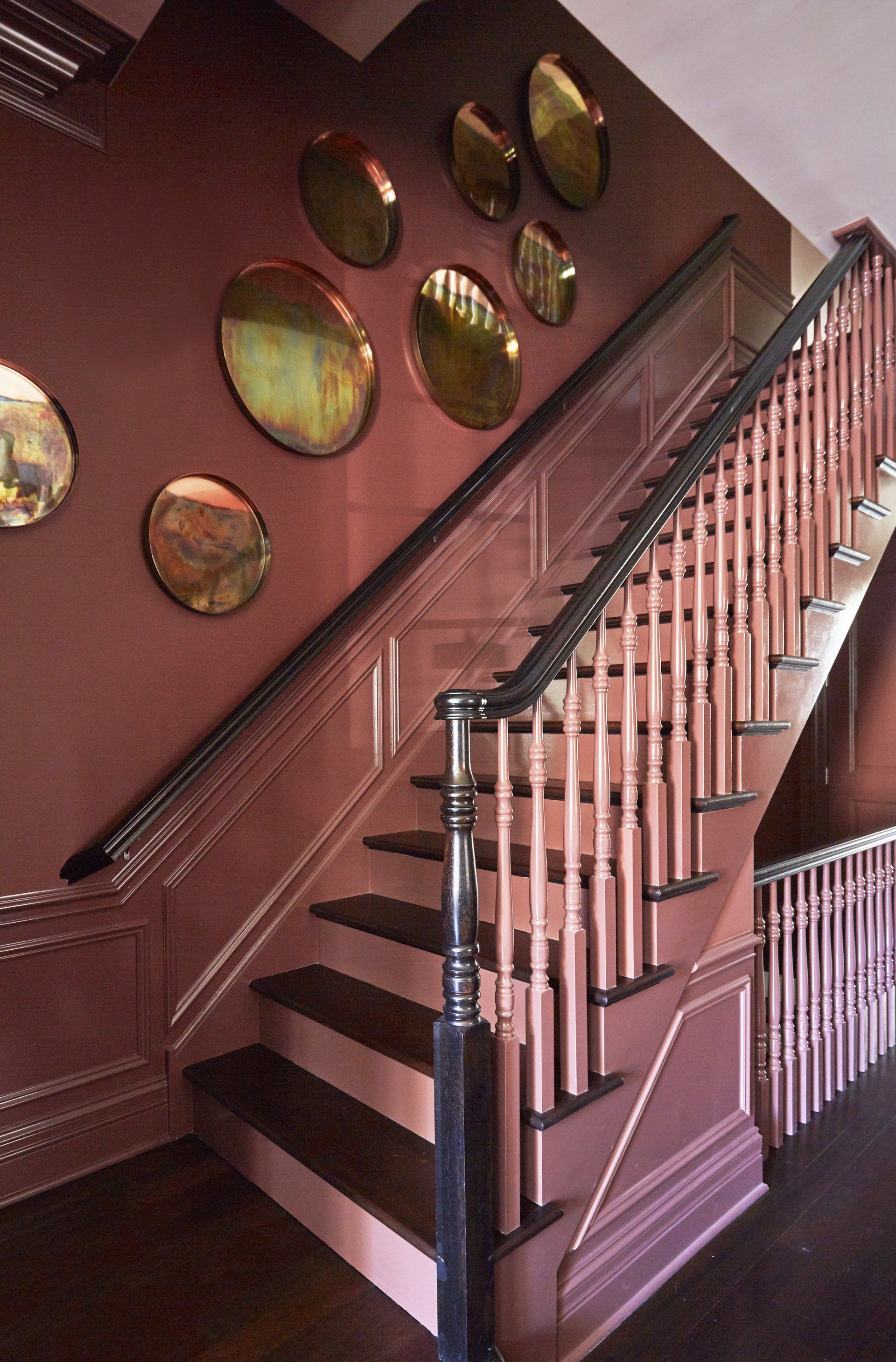 A staircase with mirrors on the wall behind it