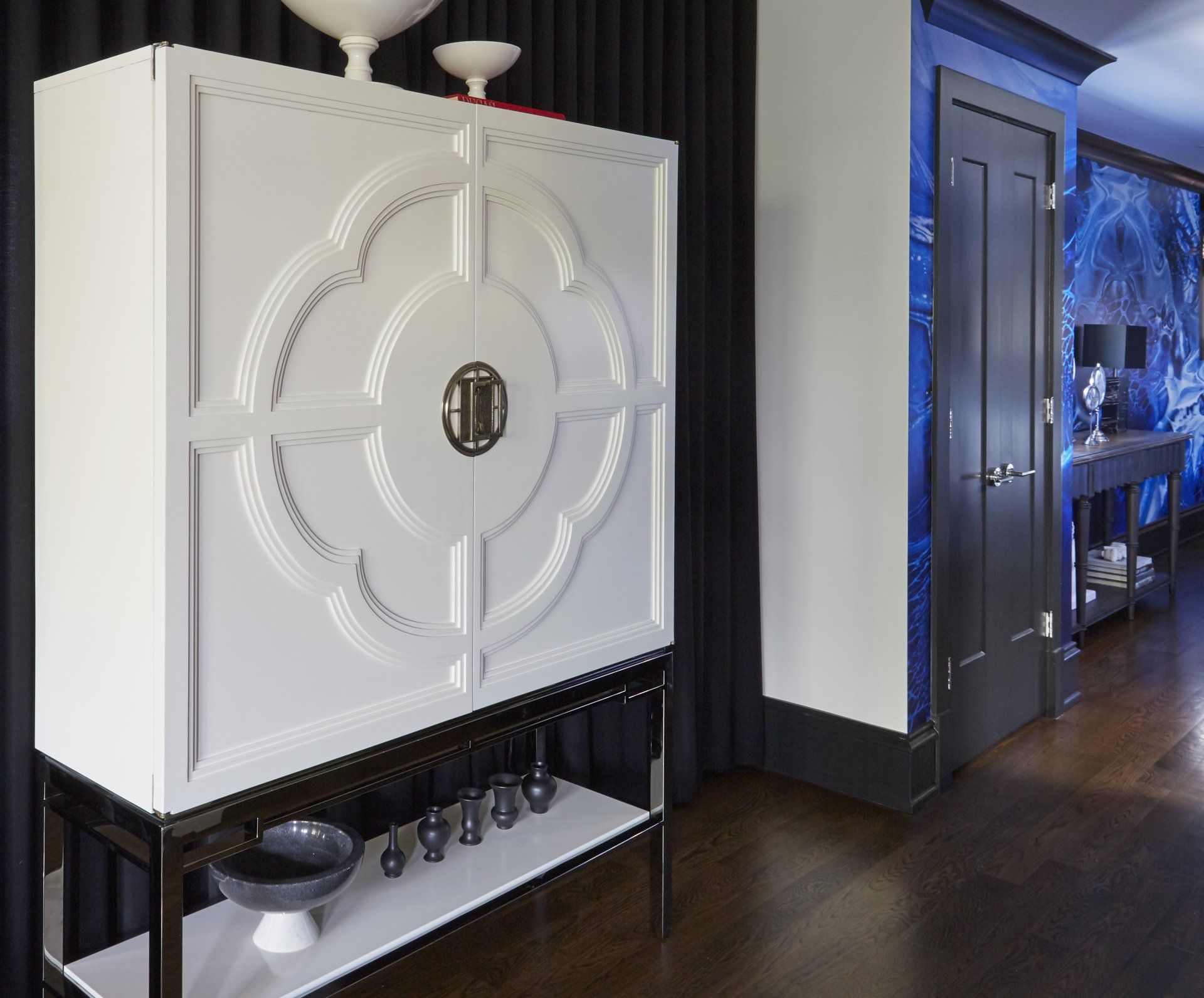 A white cabinet with a circular design on the doors