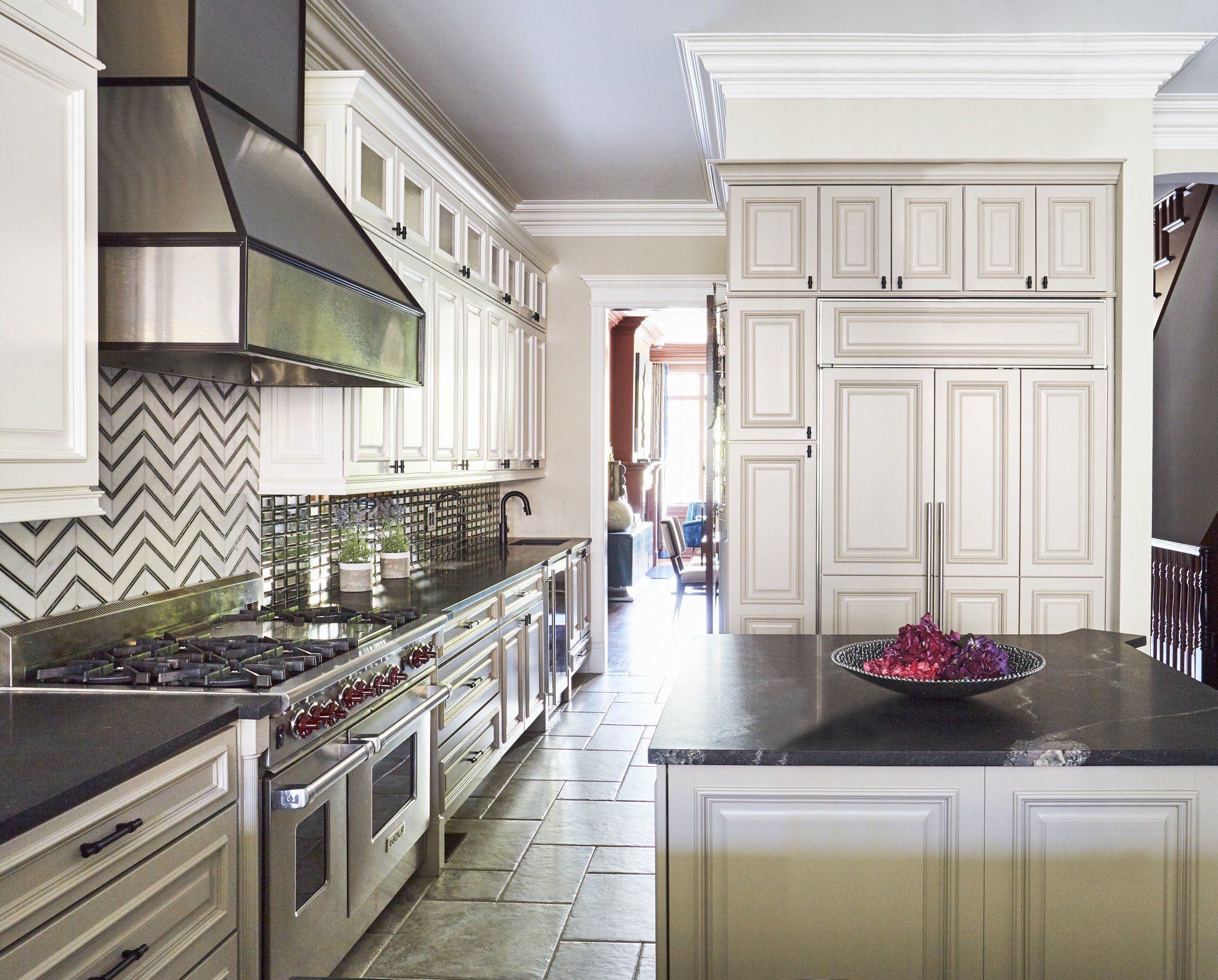 A kitchen with white cabinets and stainless steel appliances