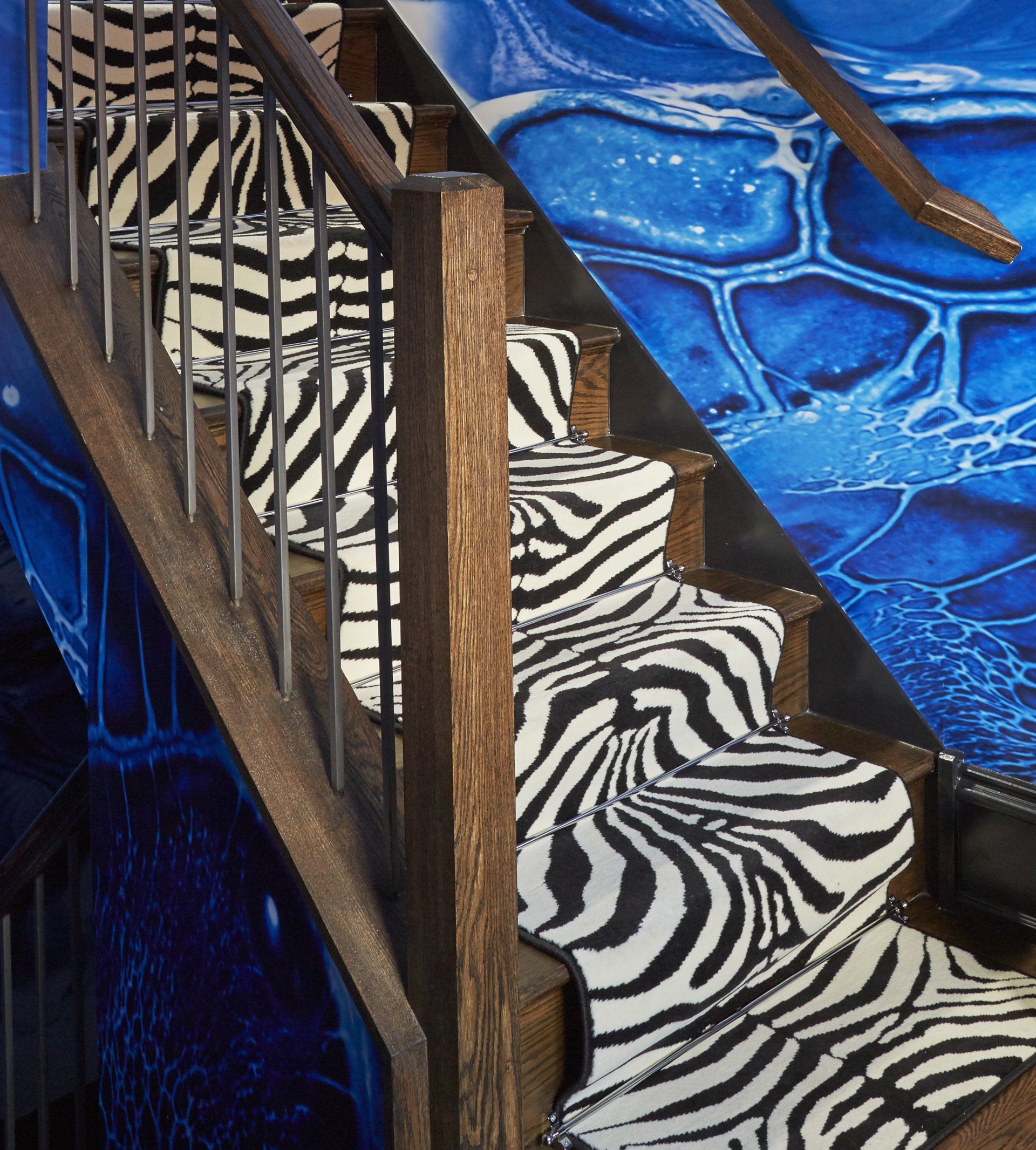 A staircase with a zebra print carpet on the steps