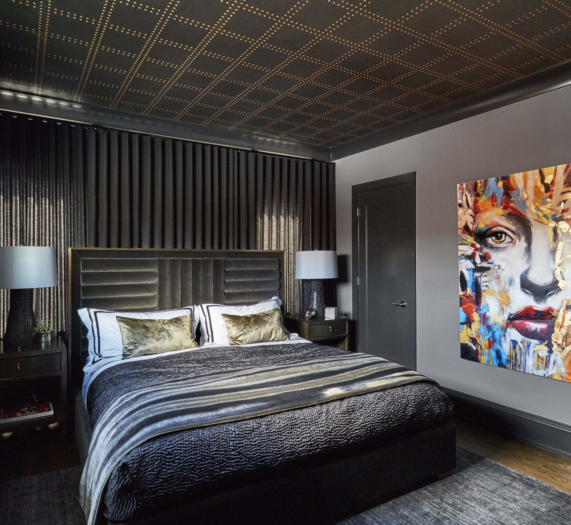 A bedroom with a bed and a painting on the wall