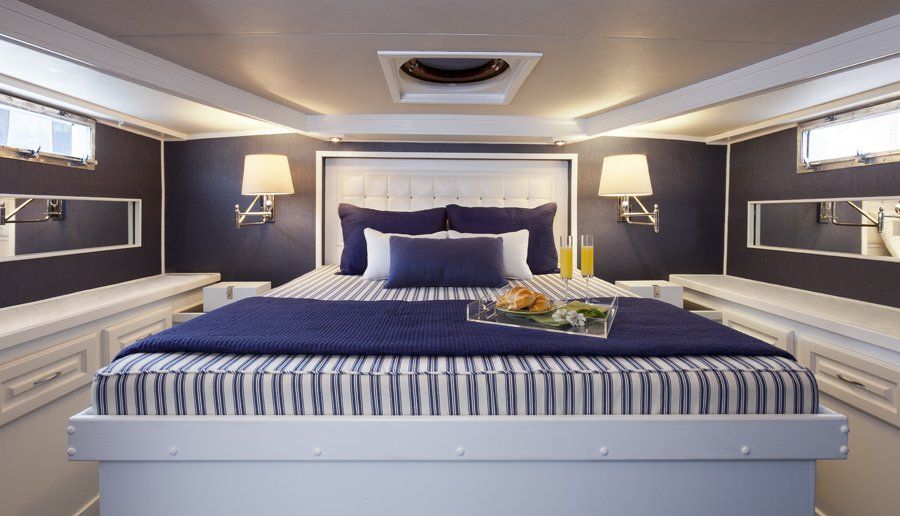 A bedroom with a large bed and a tray of food on it