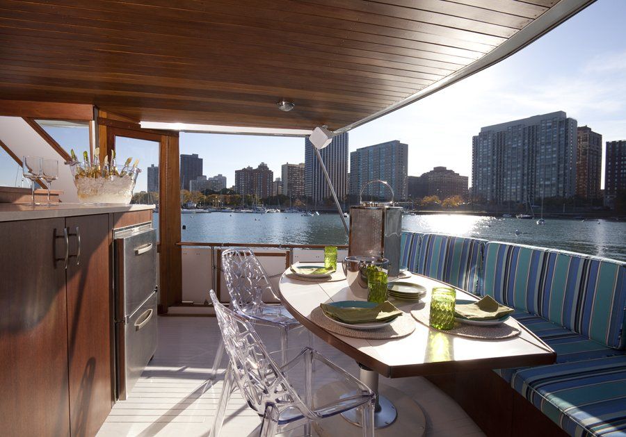 A table and chairs on a boat overlooking a body of water
