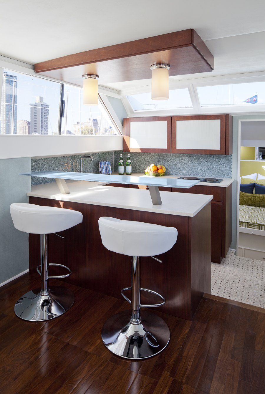 A kitchen with a bar and two bar stools