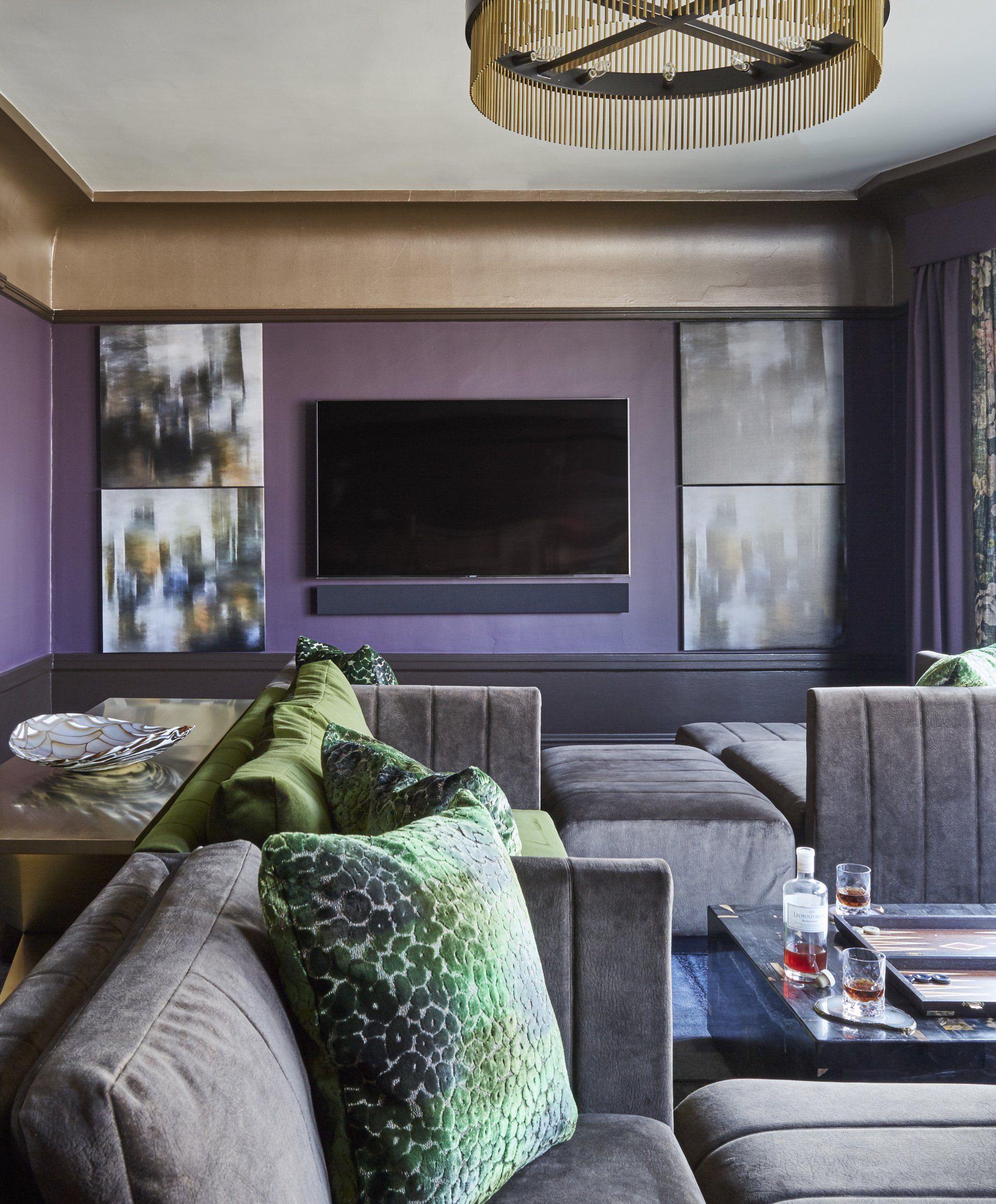 A living room with a couch and a television on the wall