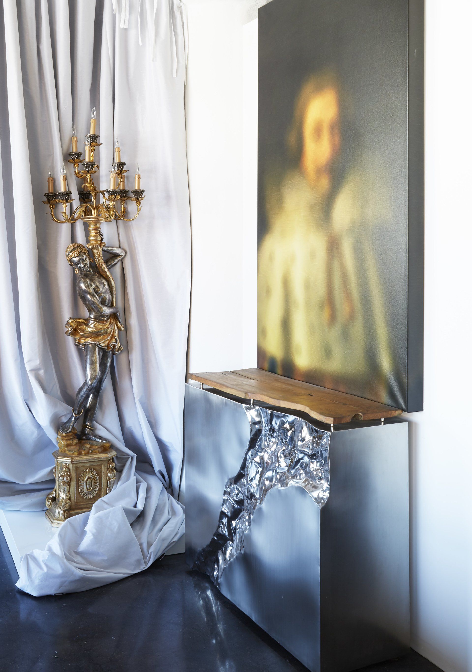 A room with a painting on the wall and a candle holder