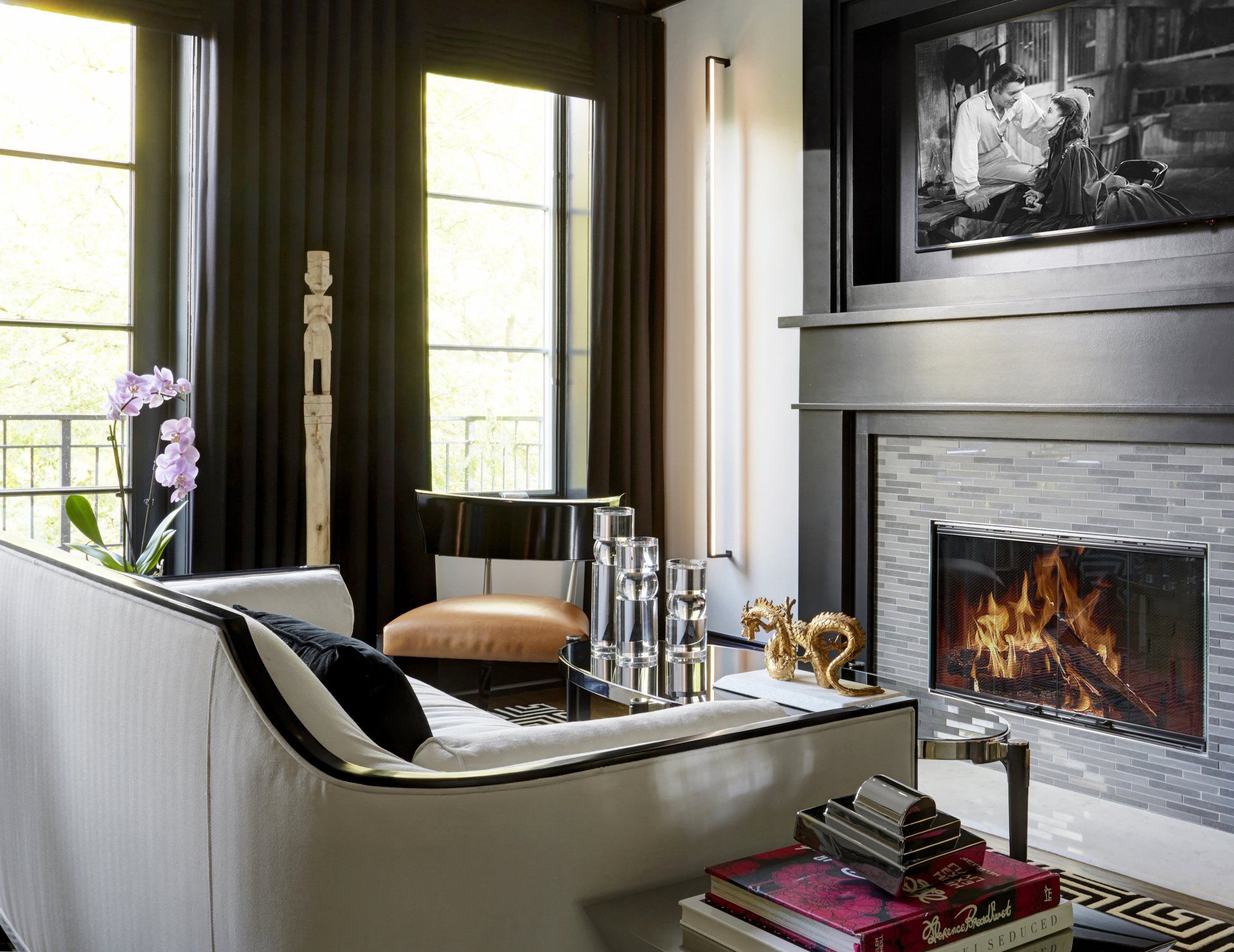 A living room with a fireplace and a flat screen tv