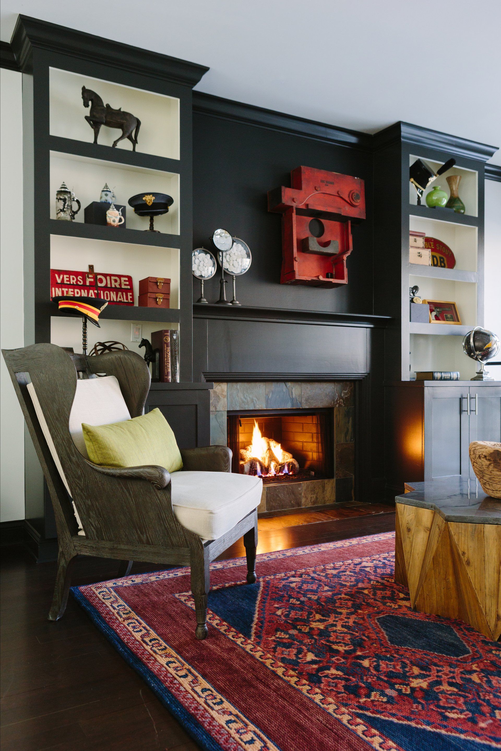 A living room with a fireplace and a chair