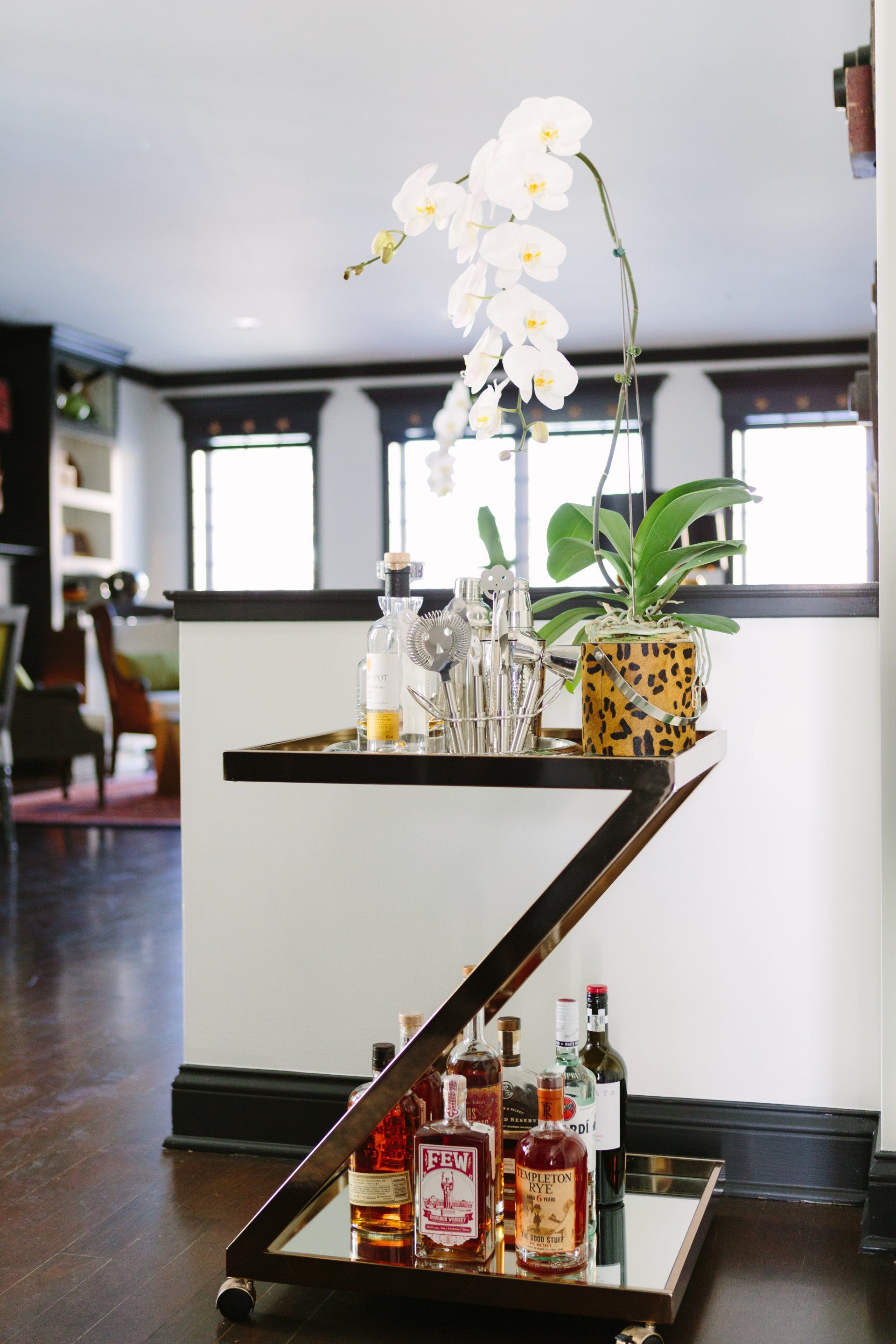 A bar cart with bottles of liquor on it