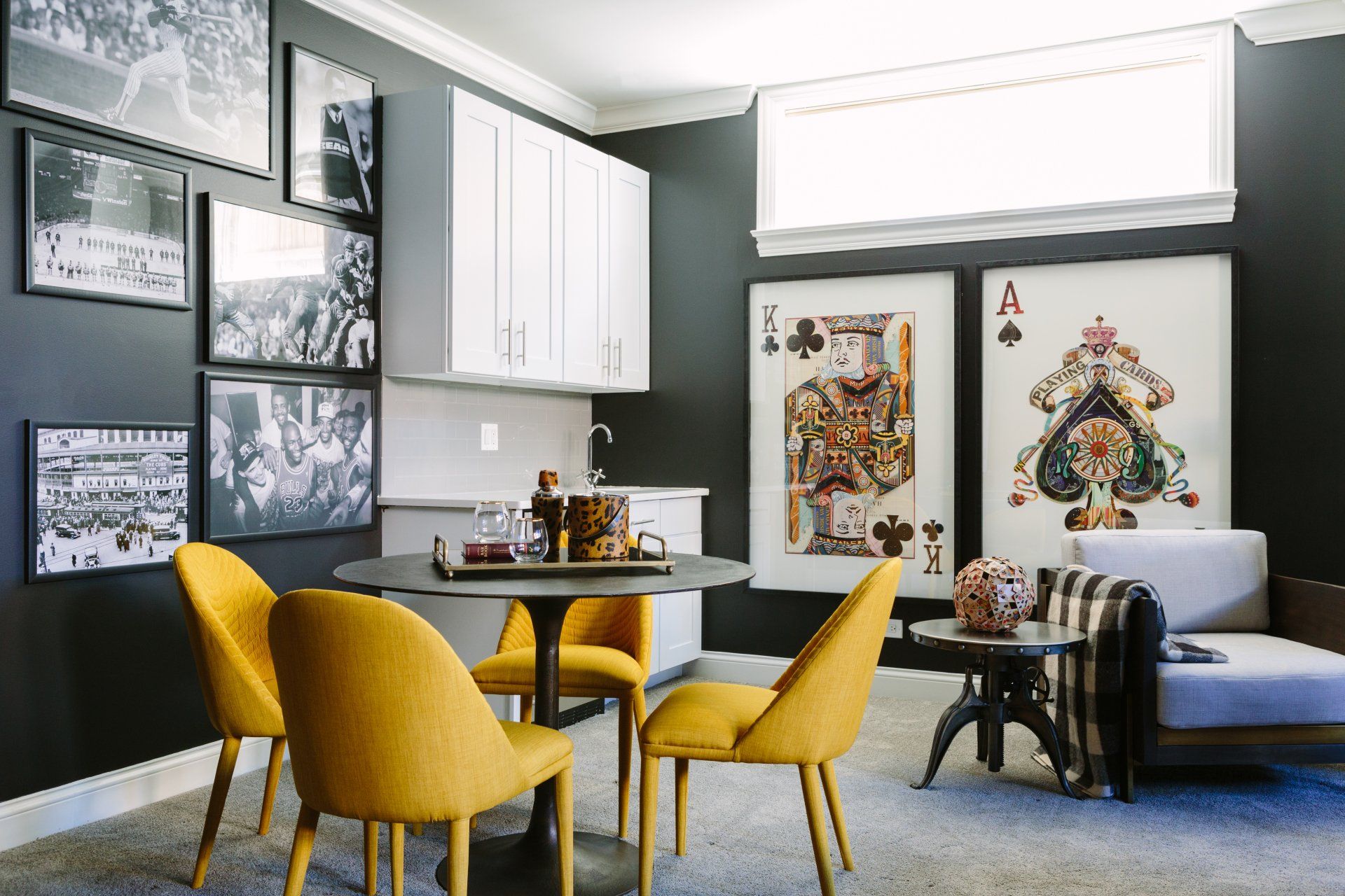 A living room with a table and chairs and a couch.