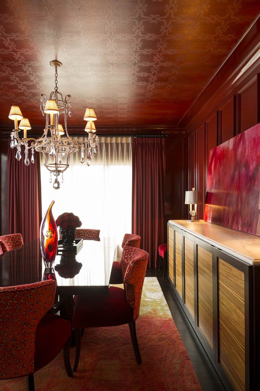 A dining room with a table and chairs and a chandelier