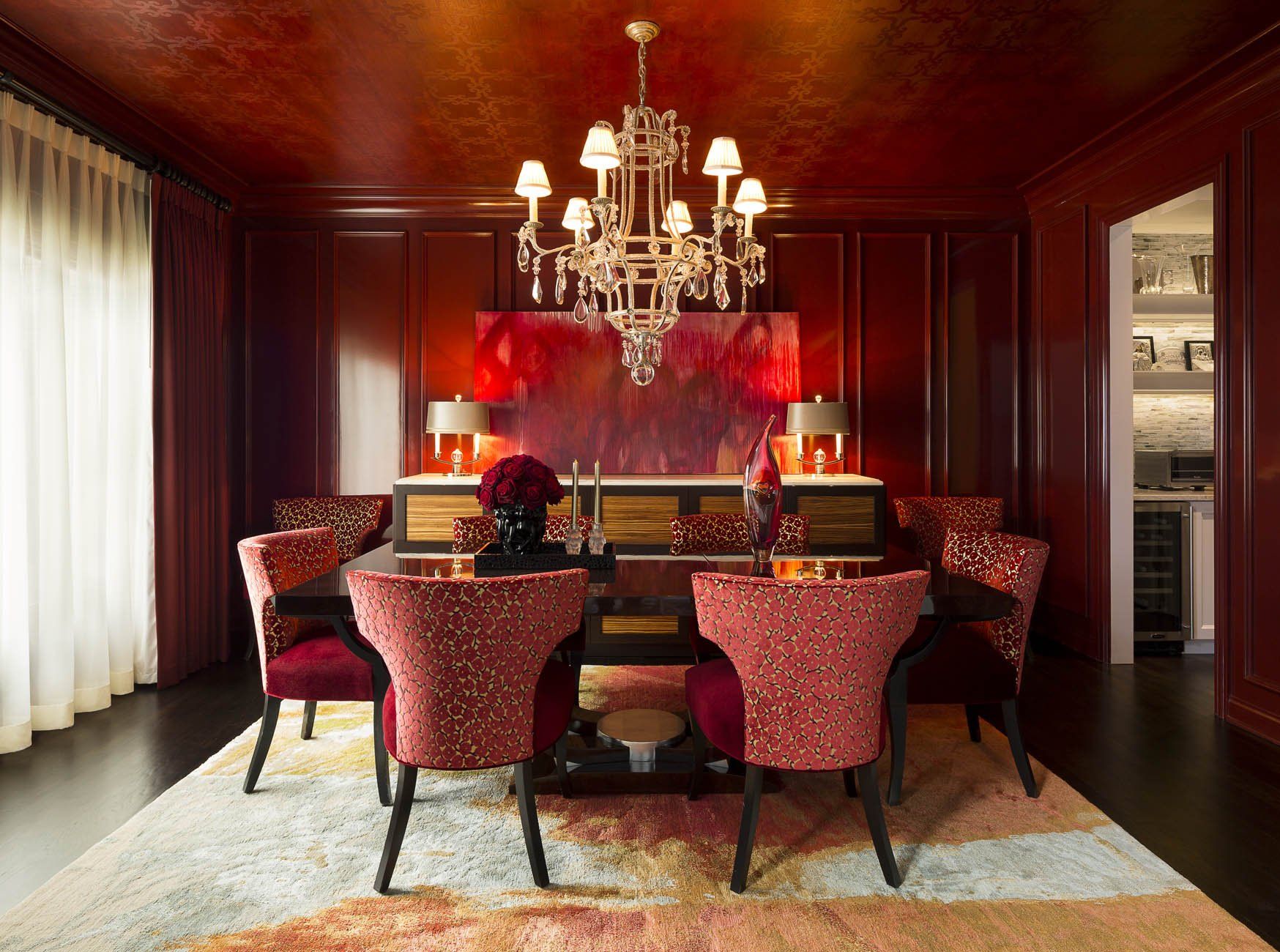 A dining room with a table and chairs and a chandelier