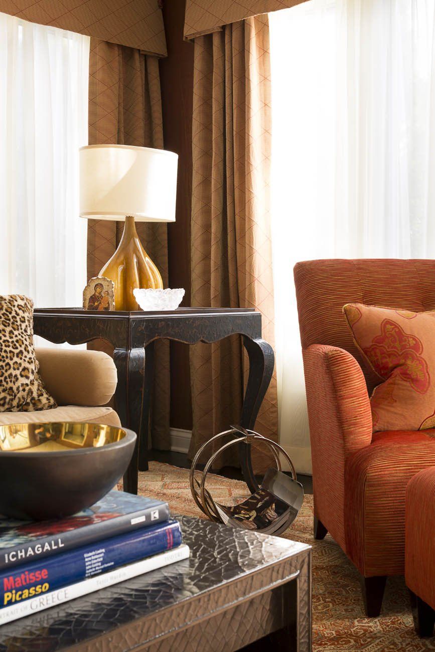 A living room with a chair a table and a lamp