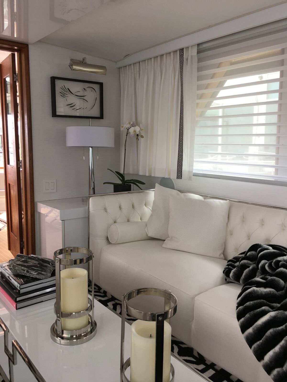 A living room with a white couch and candles on the table