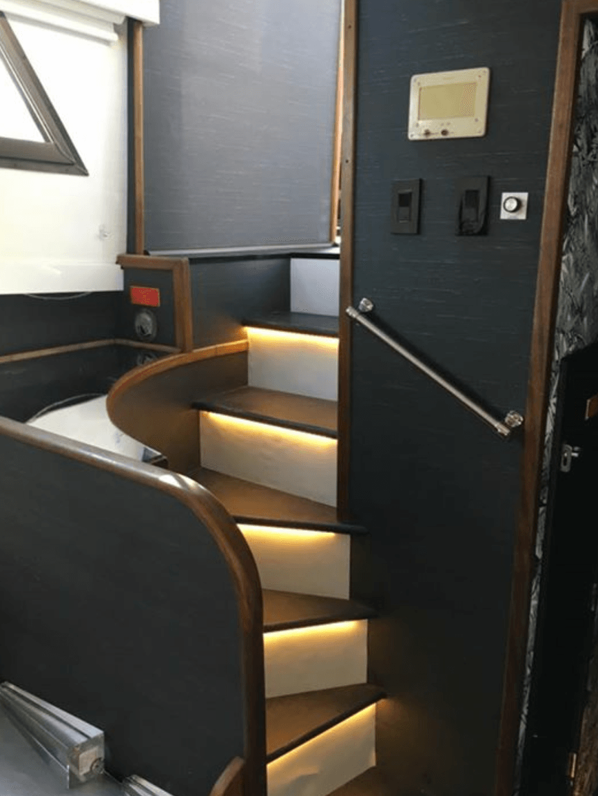 A set of stairs leading up to the second floor of a boat