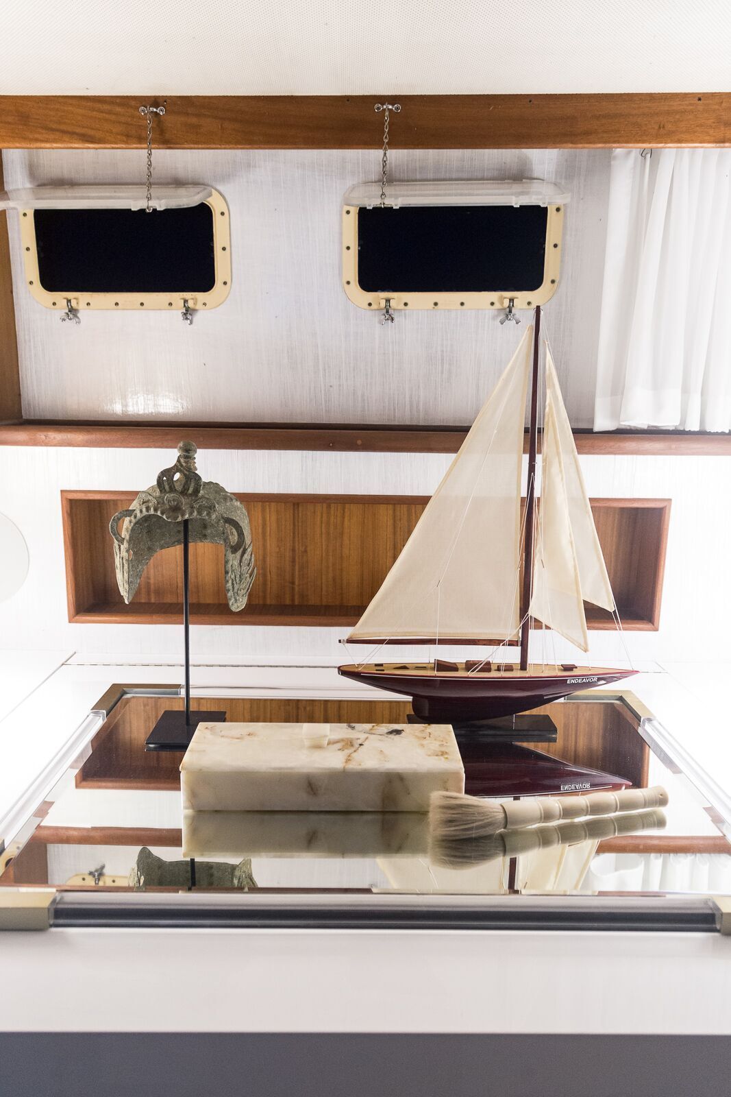 A small sailboat is sitting on top of a table in a room.