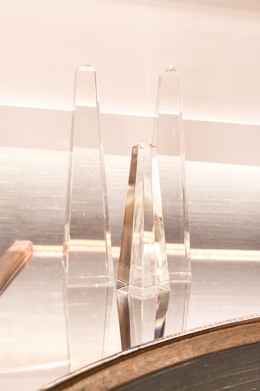 A couple of clear trophies sitting on top of a table.