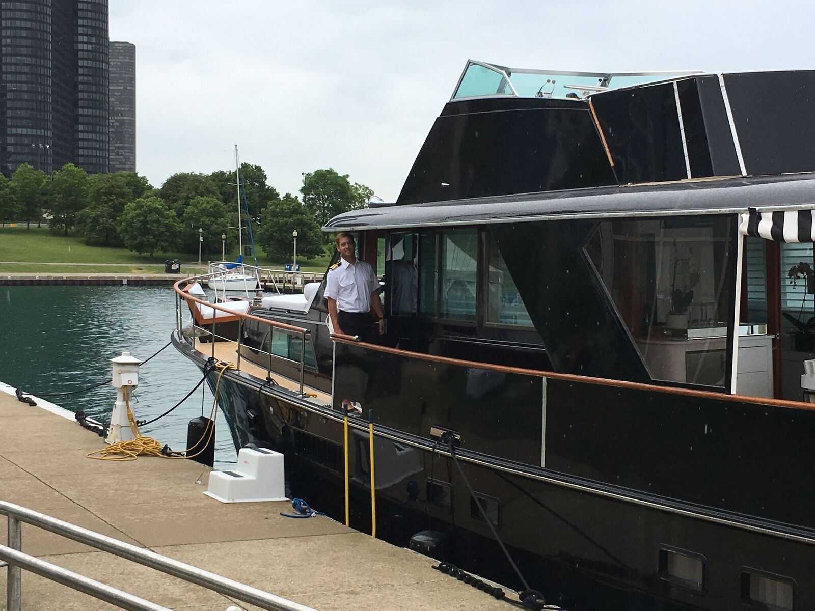A man is standing on the deck of a boat