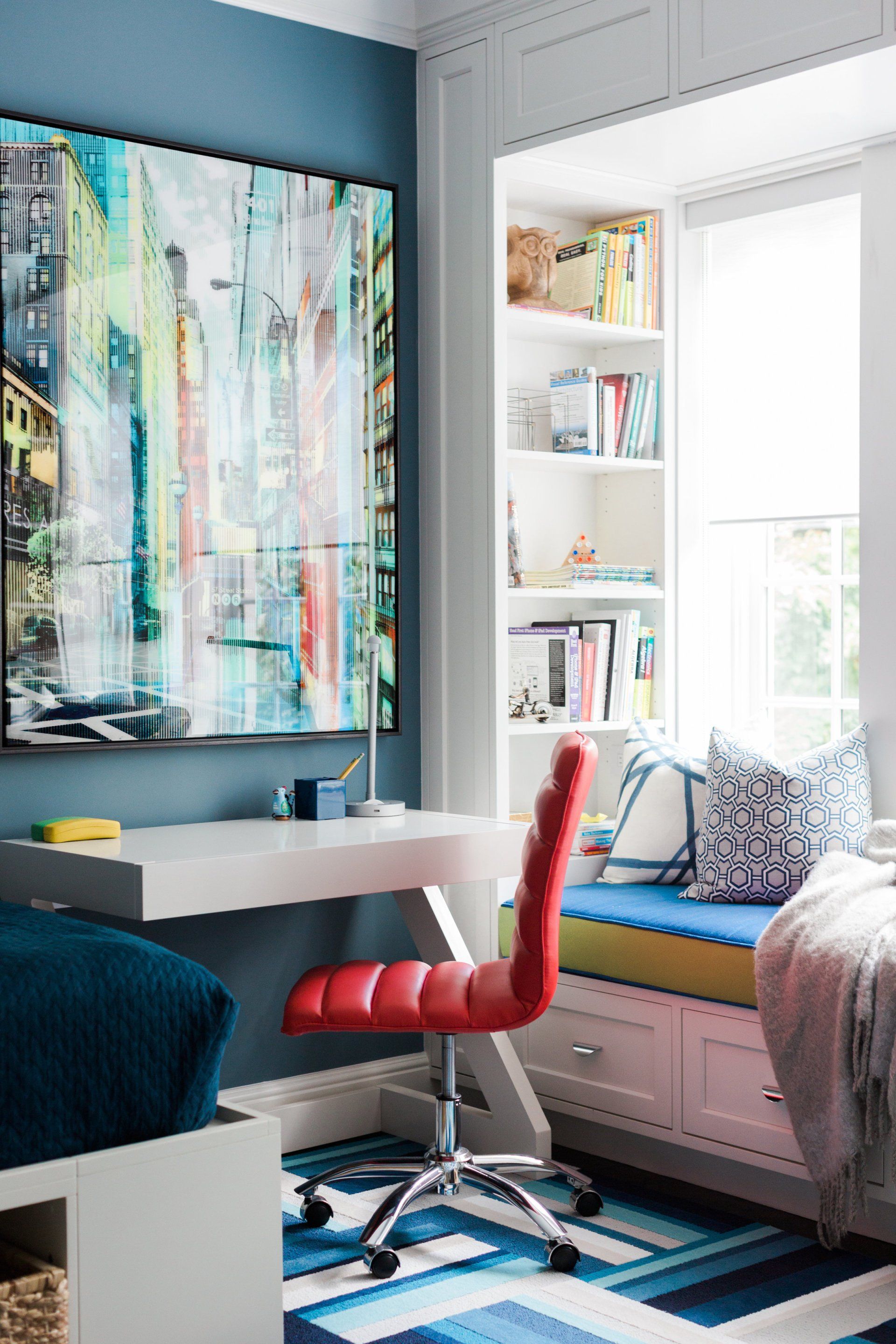 There is a painting on the wall above the desk in the room.