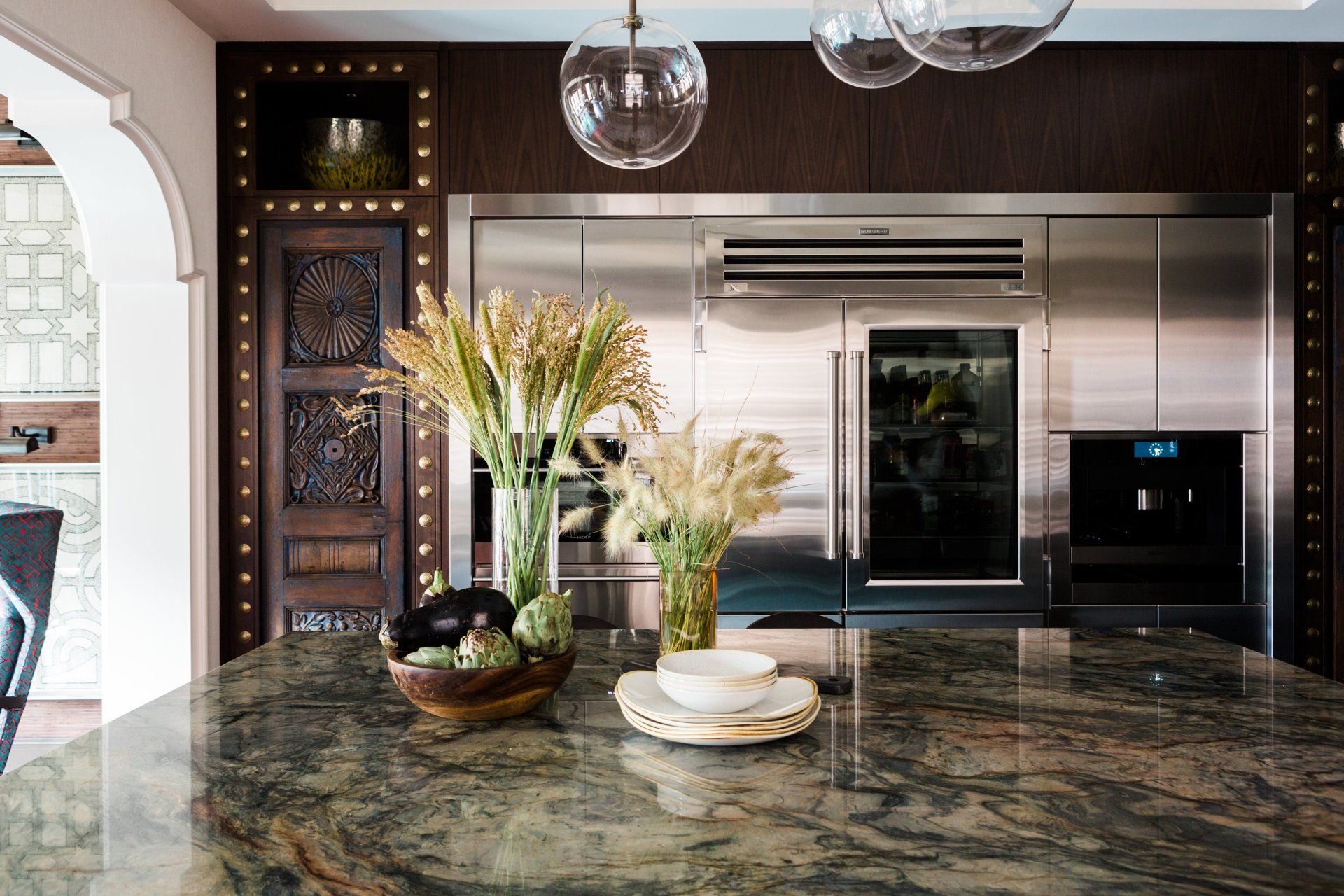 A kitchen with stainless steel appliances and a granite counter top.