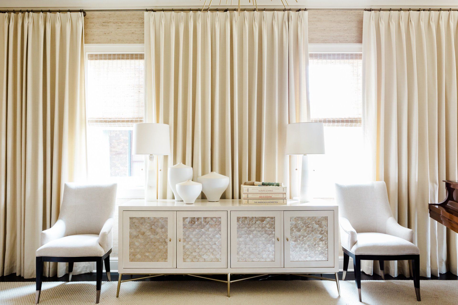 A living room with two chairs and a dresser