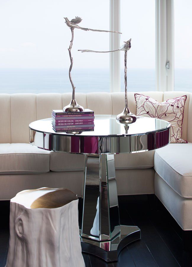 A living room with a round table and a stool