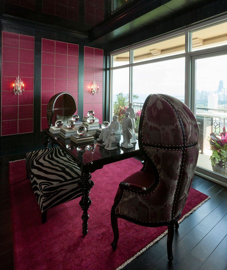 A room with a table and chairs and a large window
