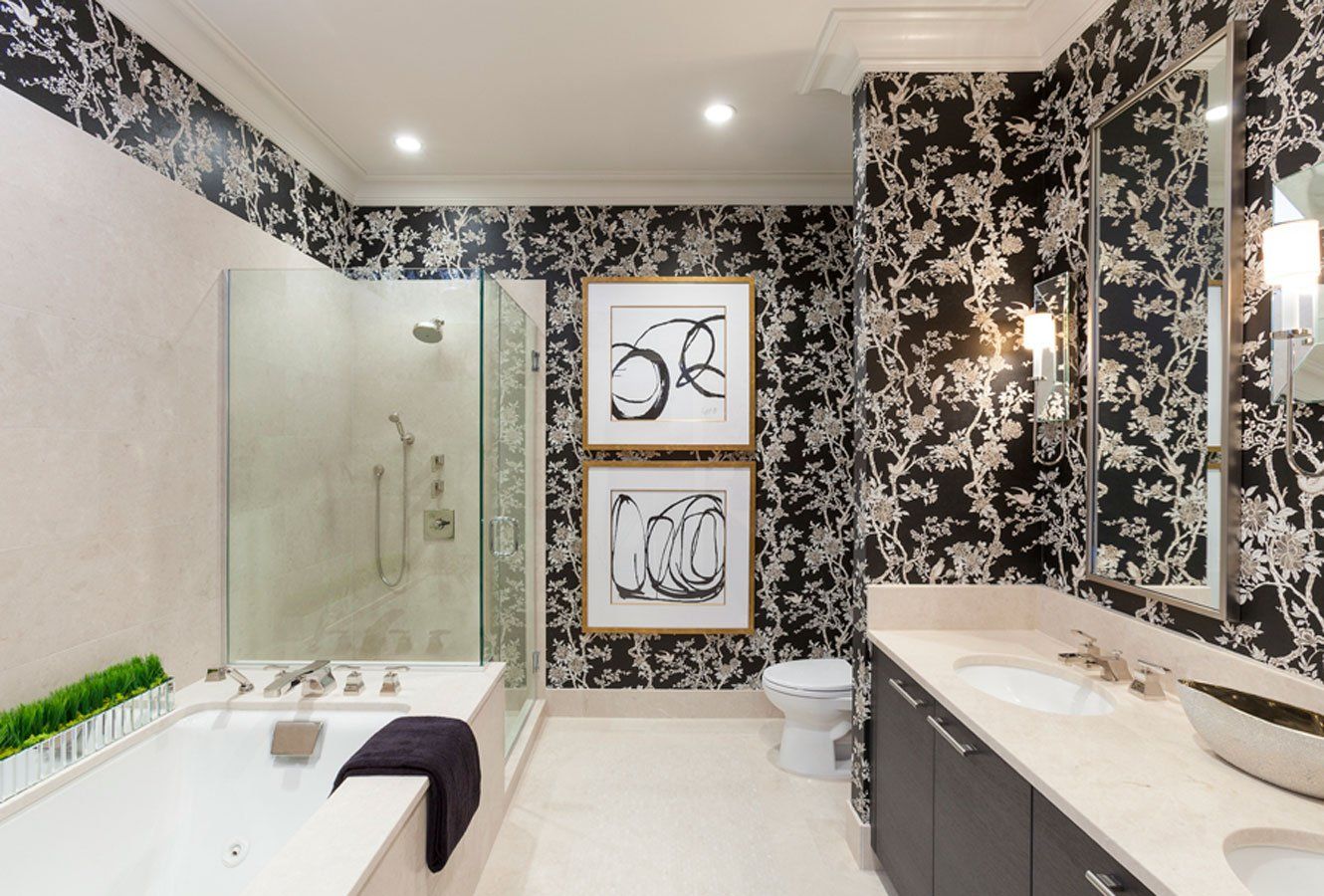 A bathroom with a bathtub , sink , toilet and shower.