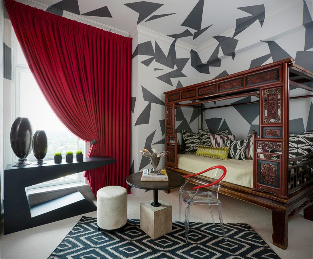 A bedroom with a canopy bed and a table