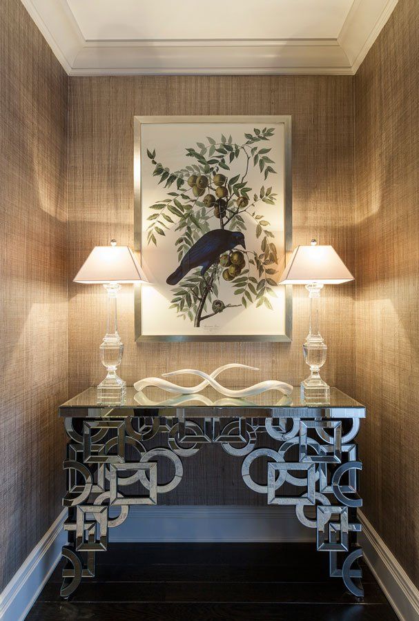 There is a picture of a bird on the wall above a table.