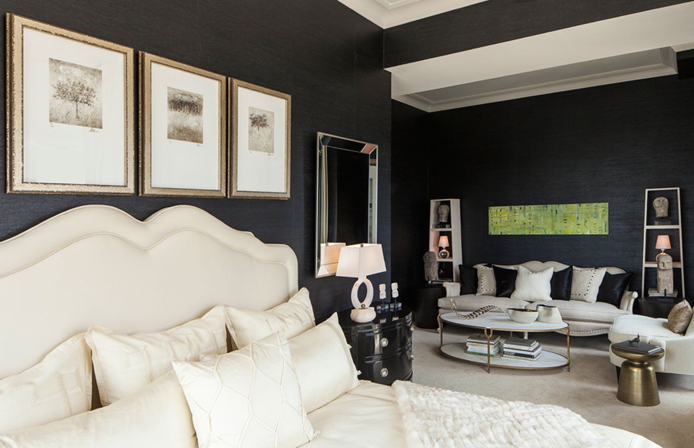 A bedroom with a large bed and a living room