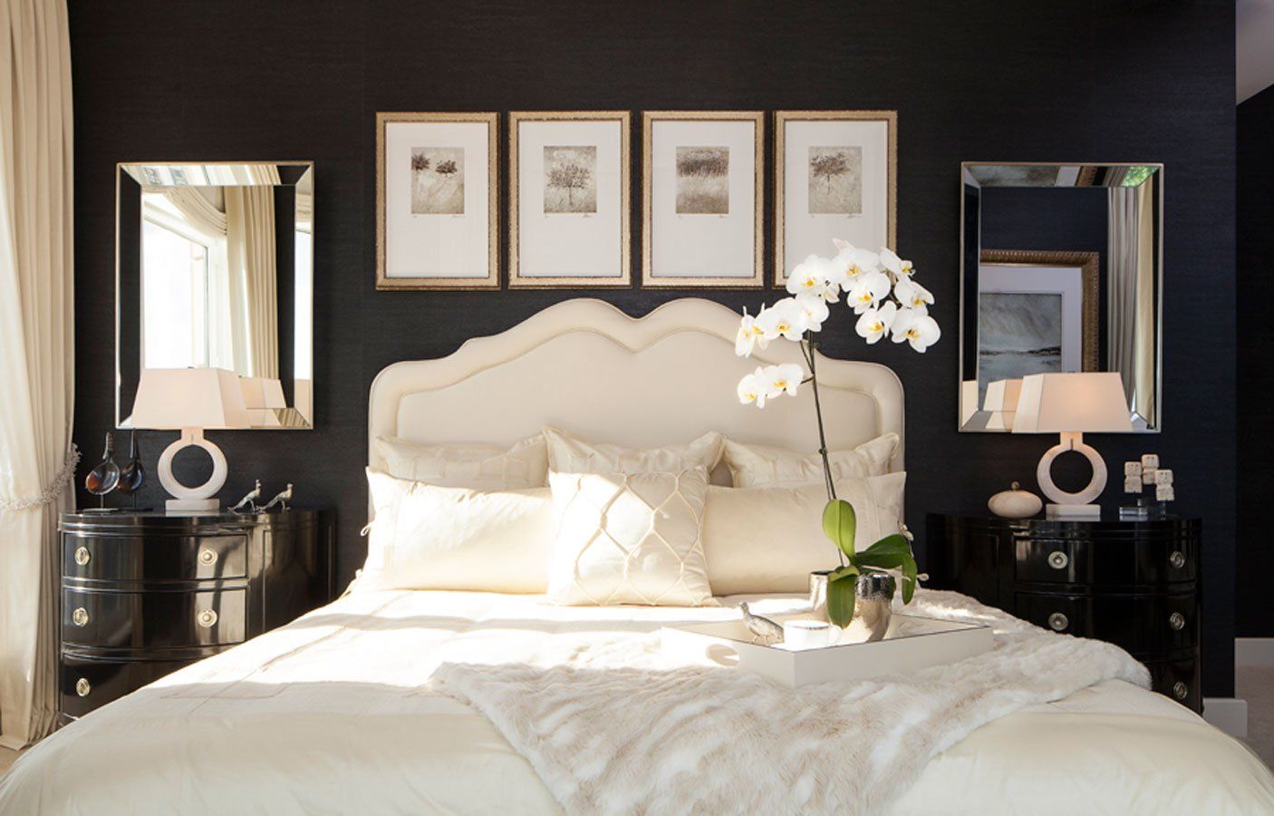 A bedroom with a bed and two mirrors on the wall