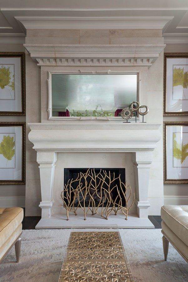 A living room with a fireplace and a mirror