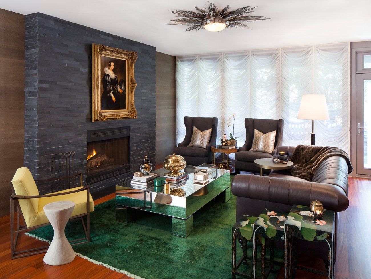 A living room with a couch , chairs , coffee table and fireplace.