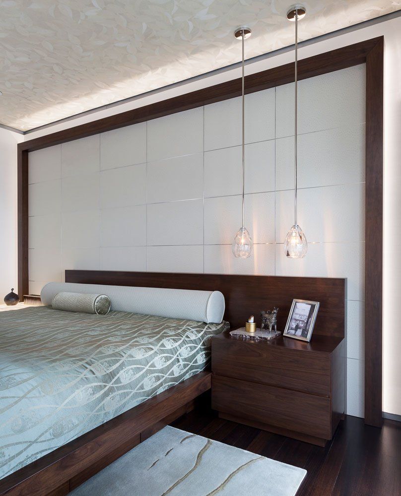A bedroom with a large bed and a nightstand
