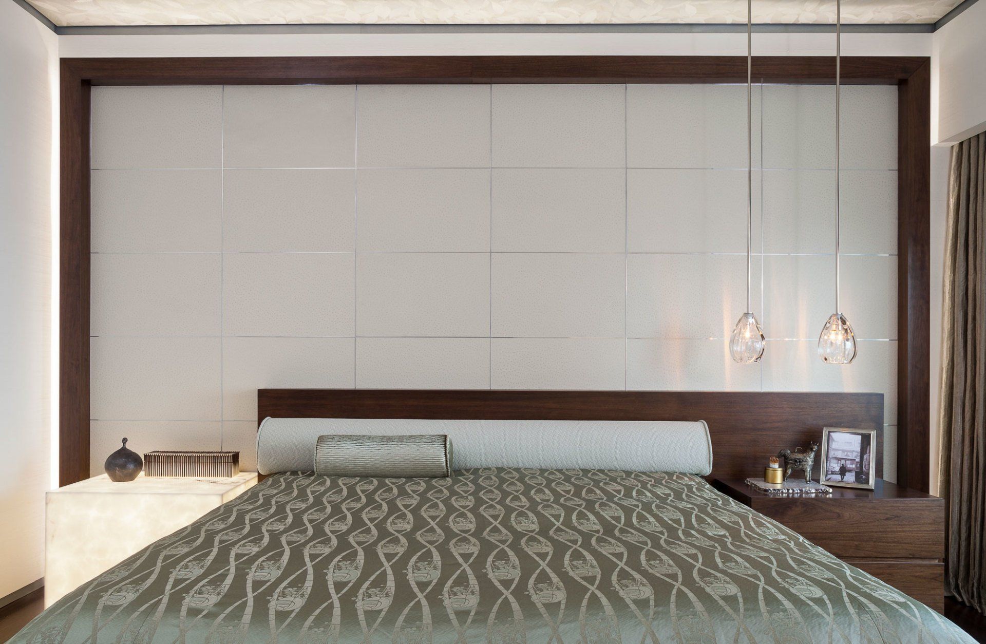 A bedroom with a large bed and a white wall