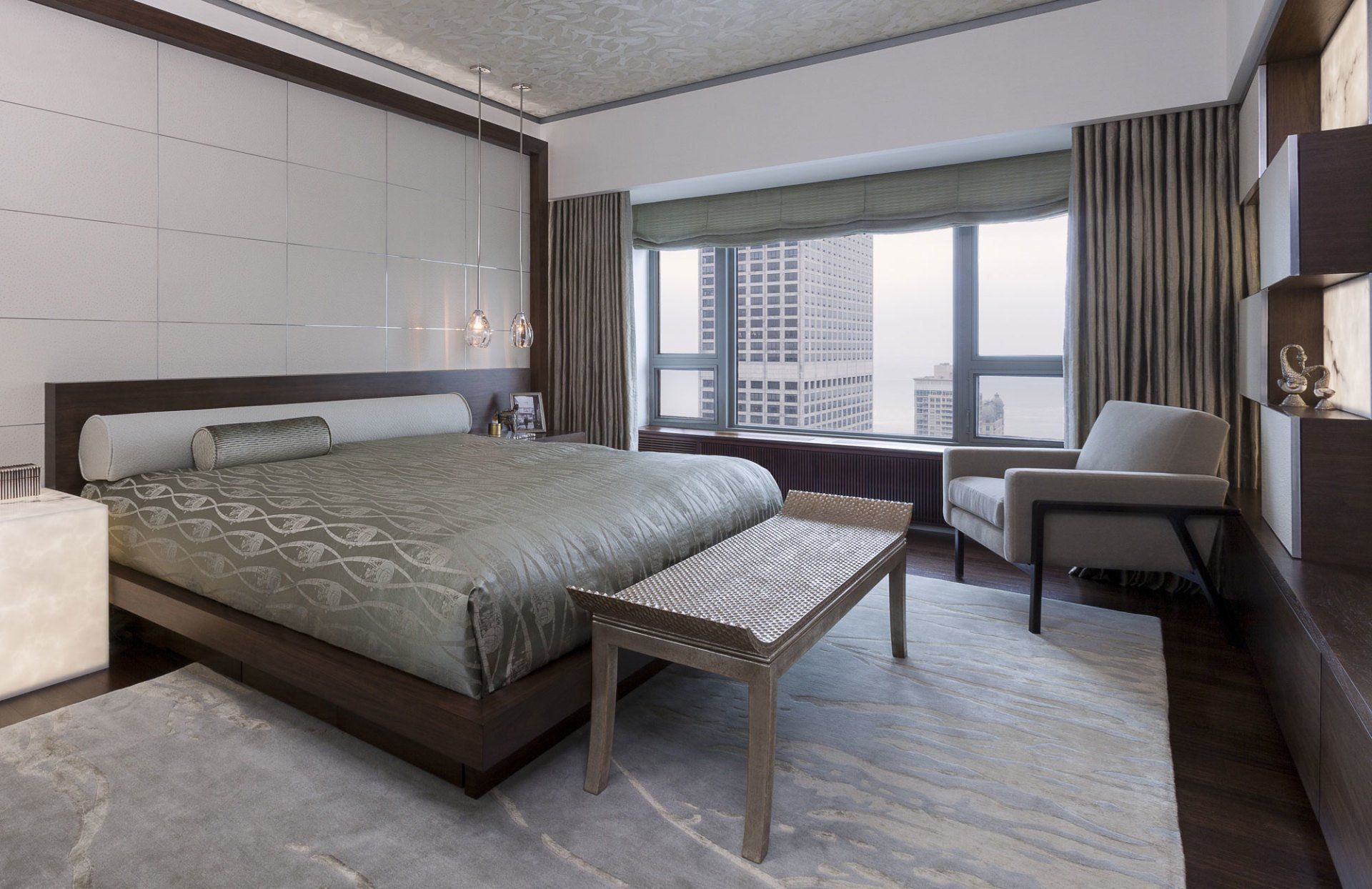 A bedroom with a large bed and a bench