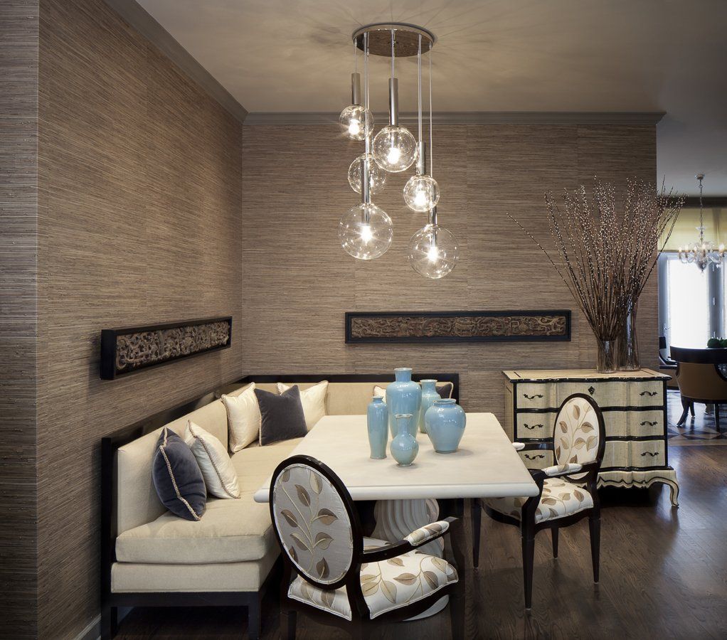 A dining room with a table and chairs and a couch