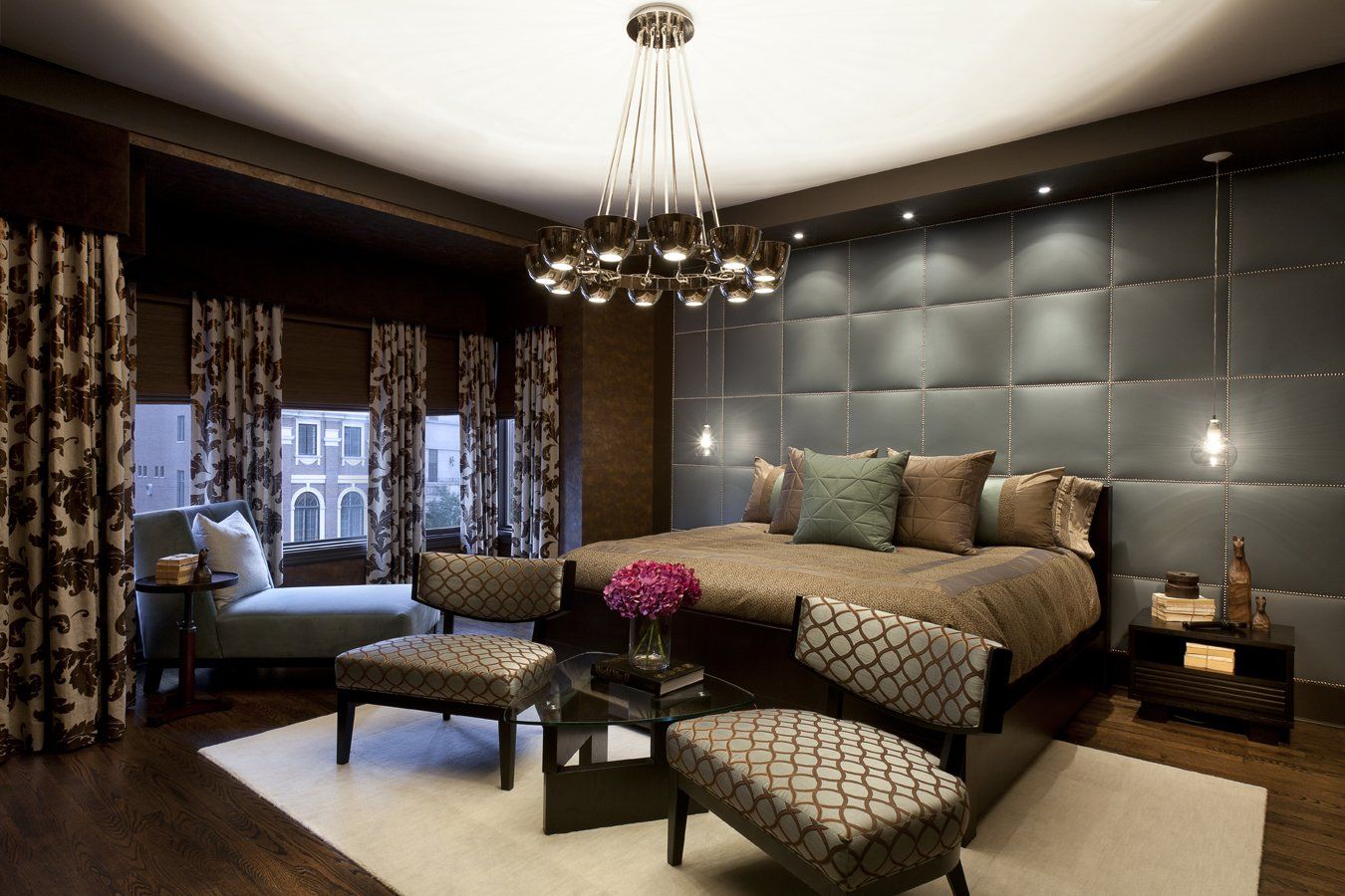 A bedroom with a large bed and a chandelier