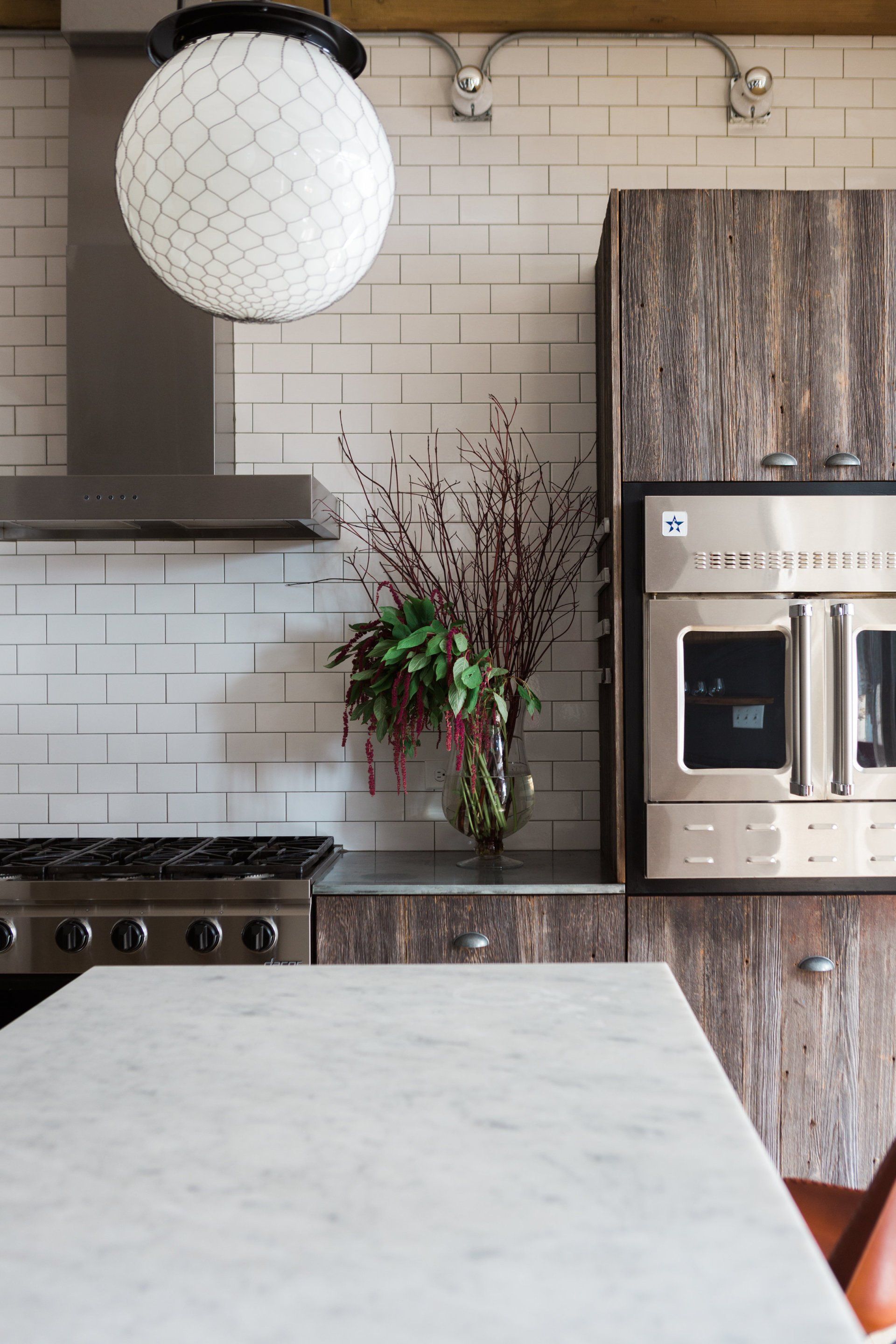 A kitchen with stainless steel appliances and wooden cabinets