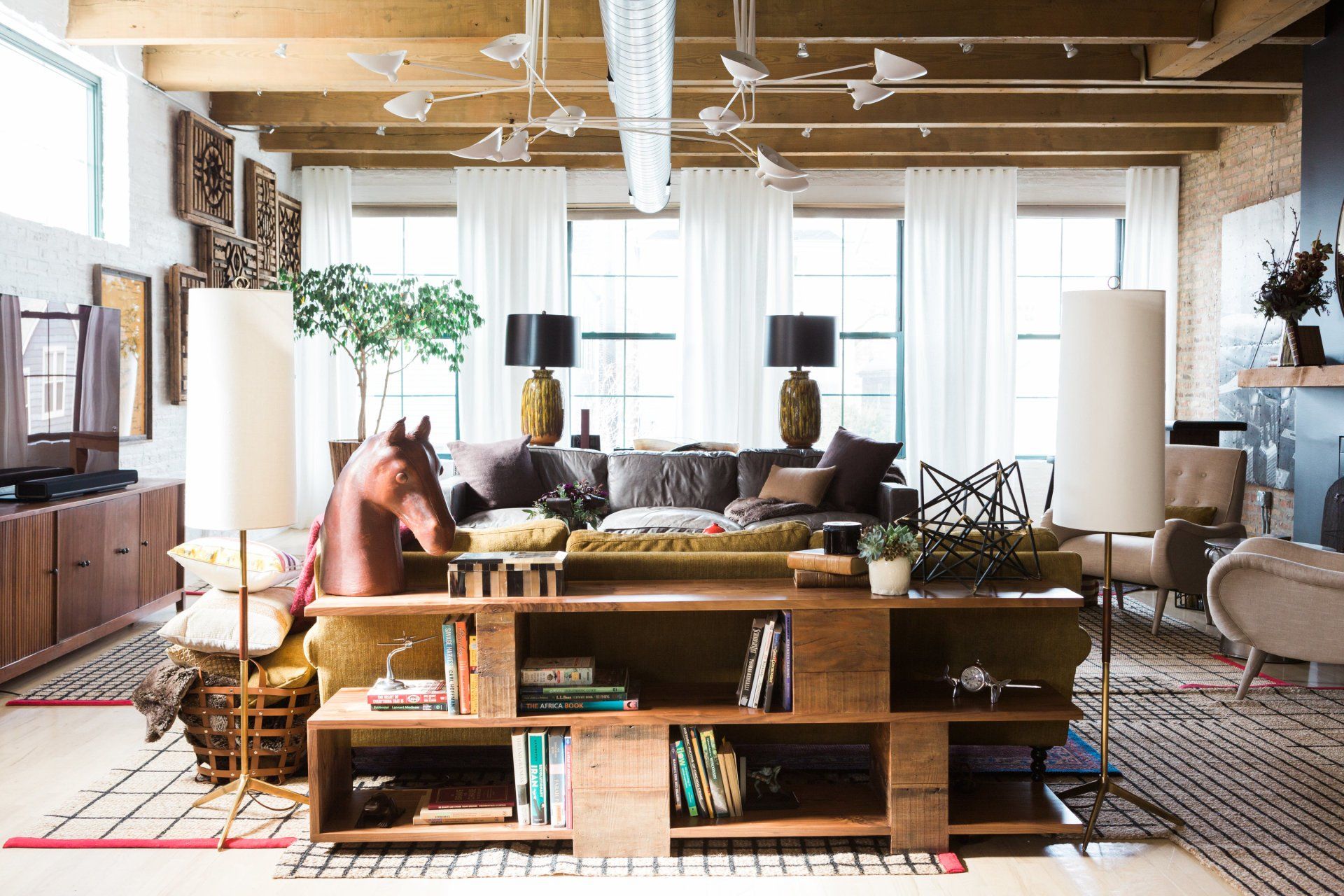 A living room filled with furniture and a horse statue