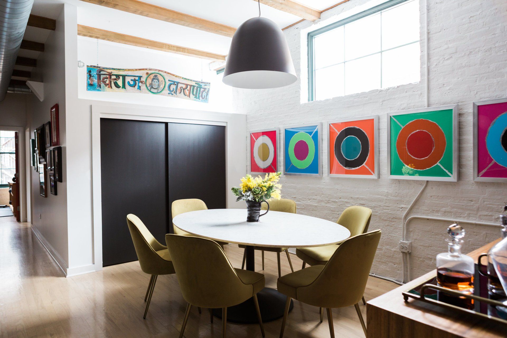 A dining room with a round table and chairs