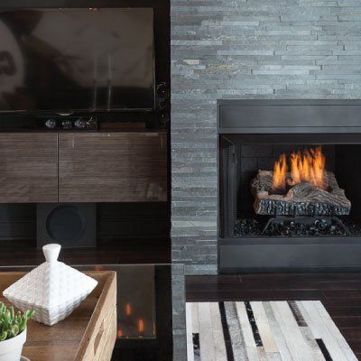 A living room with a fireplace and a flat screen tv
