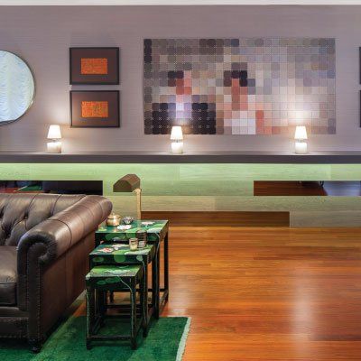A living room with a couch and a painting on the wall